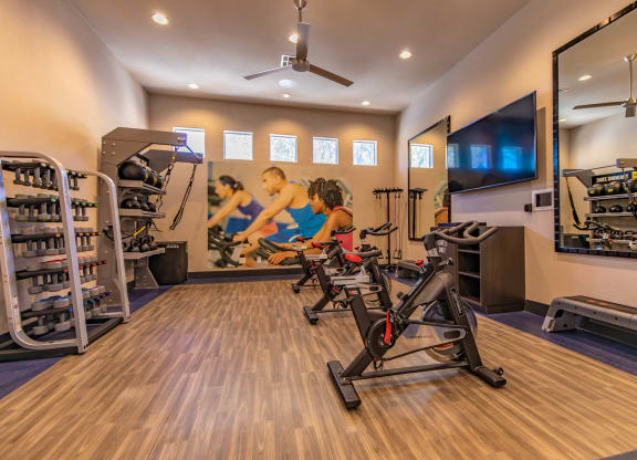 Gym with cardio machines and weights at The Covington by Picerne, Nevada
