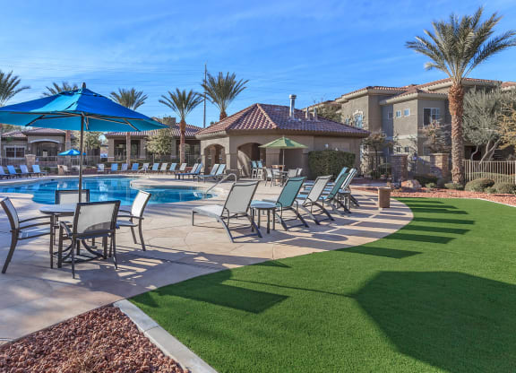 Swimming Pool Area With Shaded Chairs at The Covington by Picerne, Nevada, 89139