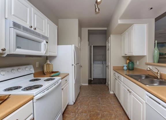 Wooden and white combo appliances at The Covington by Picerne, Las Vegas, NV