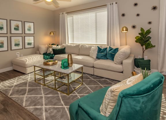 Livng room with couch and frames at Level 25 at Cactus by Picerne, Las Vegas, NV, 89141
