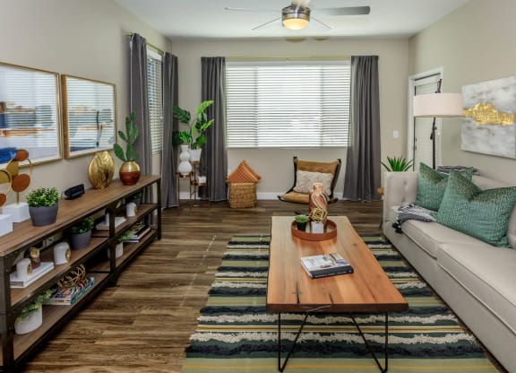 Living room decor with couch and frames along with center table at Level 25 at Sunset by Picerne, Las Vegas, 89113