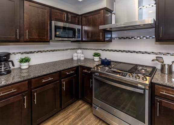 Kitchen with wooden cabinets at Level 25 at Sunset by Picerne, Nevada