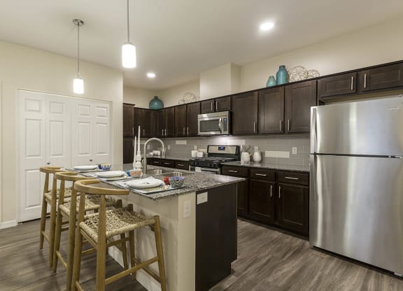 Kitchen with wooden cabinets and breakfast bar at The View at Horizon Ridge, Nevada, 89012