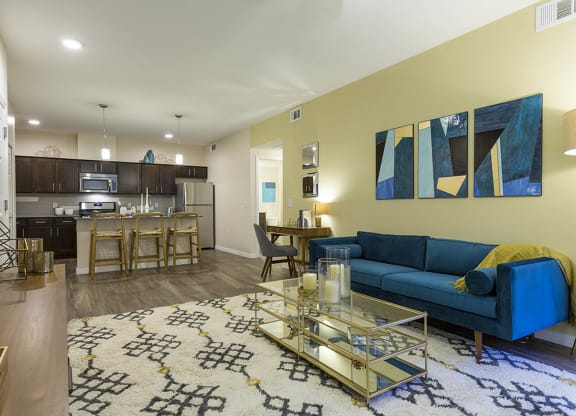 Living room with tv and couch and model kitchen at The View at Horizon Ridge, Henderson