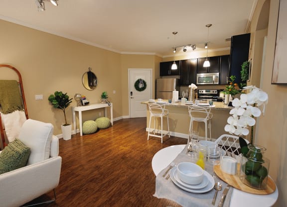 a living room and kitchen with a dining room table and chairs at The Oasis at Moss Park, Orlando, 32832
