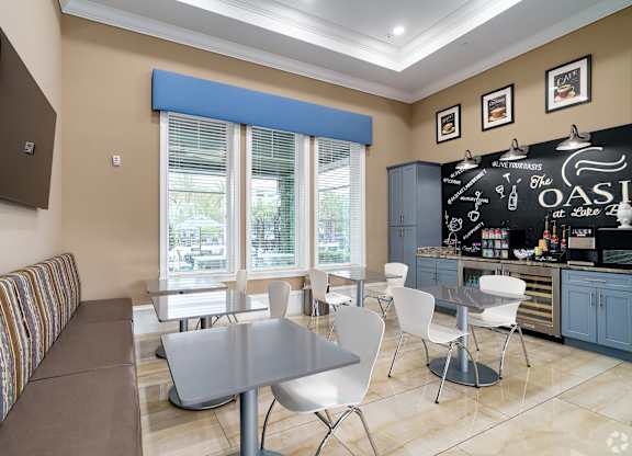 A modern kitchen with a dining table and chairs.