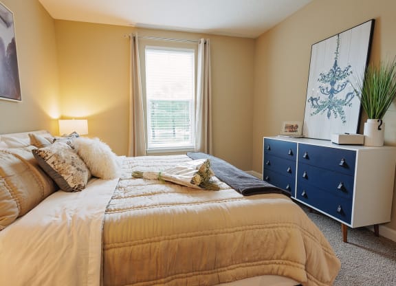 a bedroom with a bed and a dresser and a window at The Oasis at Moss Park, Florida, 32832