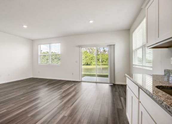 Spacious living area connected to the backyard at Beacon at Arbours in Ruskin, FL