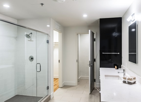 Mid Elm Lofts bathroom with walk-in shower and modern vanity in Dallas, TX