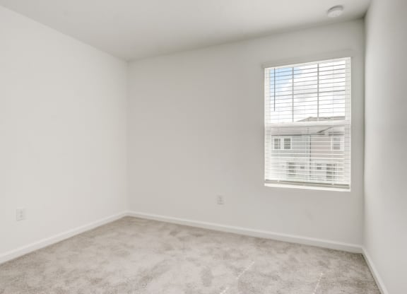 View of second bedroom with white walls and a window at Beacon at Arbours in Ruskin, FL