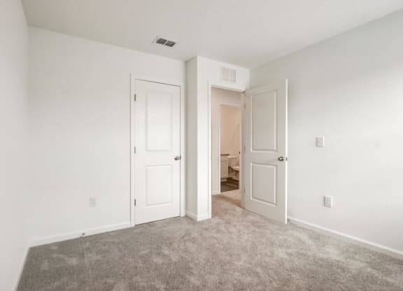 View of third bedroom with two doors and a carpeted floor area at Beacon at Arbours in Ruskin, FL