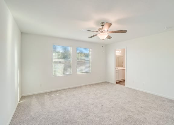 Verbena floor plan bedroom with natural lighting and ceiling fan at Beacon at Clinton Corners in Dade City, FL