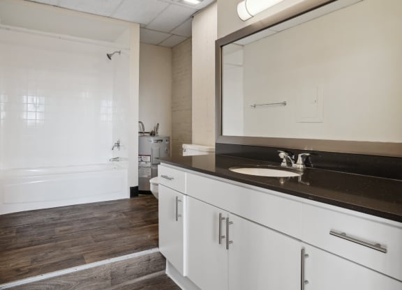 3200 Main Lofts bathroom with large vanity and step up to shower | Deep Ellum Lofts in Dallas, TX