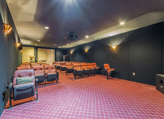 Large 35-seat theater room with selection of movies and a popcorn maker cart at Encore at Buckingham apartments in Richardson, TX