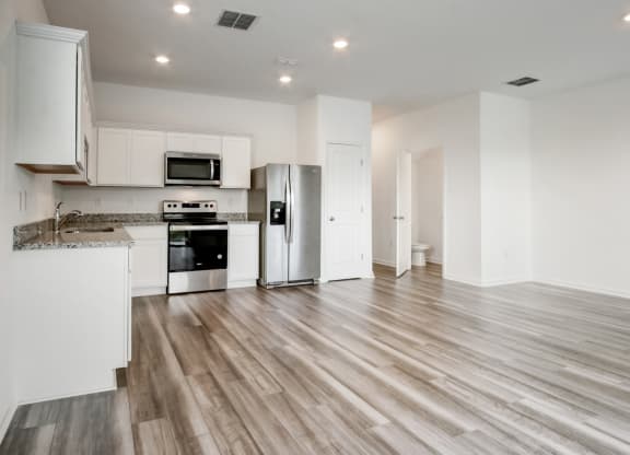 Spacious living and kitchen area with modern design at Beacon at Arbours in Ruskin, FL