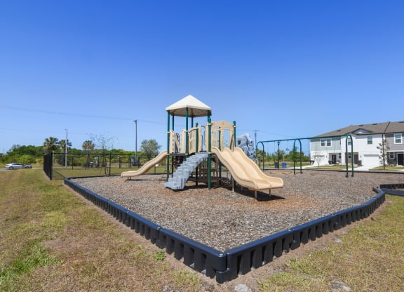 a playground with a slide and climbing structure at Beacon at Arbours, Ruskin, 33570