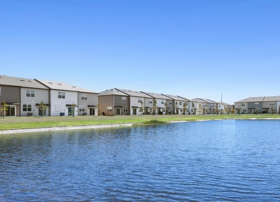a large body of water in front of a row of houses at Beacon at Arbours, Florida