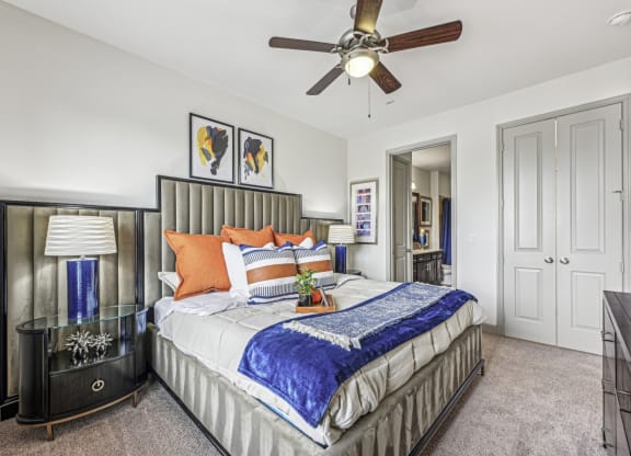 Well-decorated bedroom with comfortable bedding and stylish furnishings at Allusion at West University apartments in Houston, TX