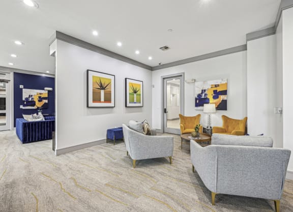 Clubroom with comfortable seating and contemporary artwork at Allusion at West University apartments in Houston, TX