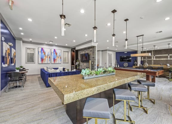 Spacious resident lounge with comfortable seating and vibrant artwork at Allusion at West University apartments in Houston, TX