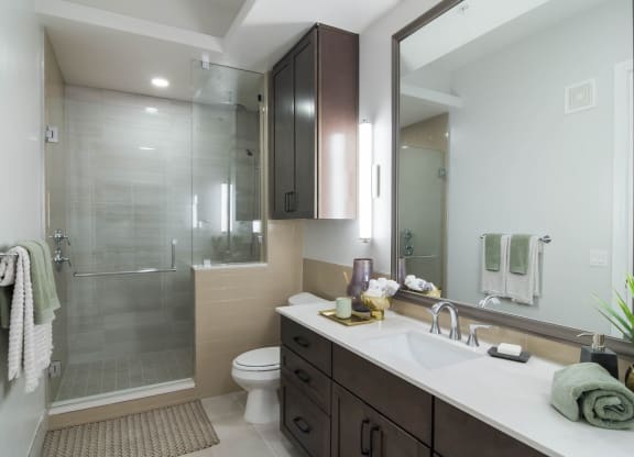 Walk-In Showers With Built-In Bench And Glass Enclosure at The Alastair at Aria Village, Sandy Springs, Georgia