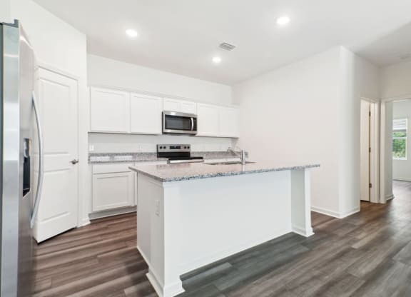 Modern kitchen with stainless steel appliances and white cabinetry at Beacon at Ashley River Landing in Summerville, SC