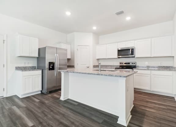 Spacious kitchen with island and granite countertops at Beacon at Ashley River Landing in Summerville, SC