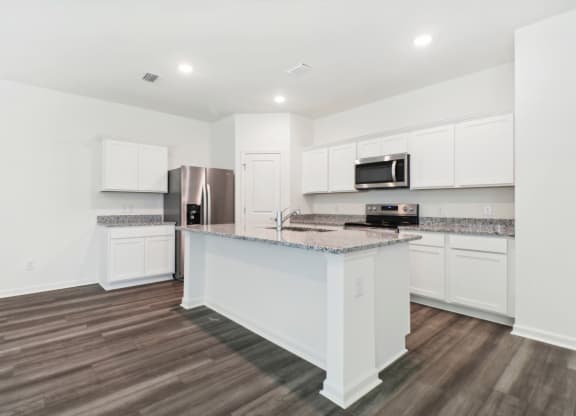 Maple kitchen with an island and a stainless steel at Beacon at Ashley River Landing in Summerville, SC