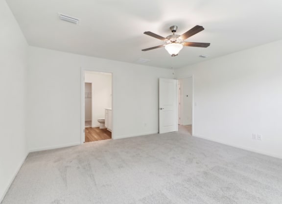 Maple bedroom with white walls and a ceiling fan at Beacon at Ashley River Landing in Summerville, SC