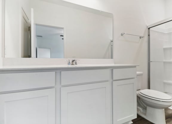 Oak master bathroom with a glass-enclosed shower at Beacon at Ashley River Landing in Summerville, SC