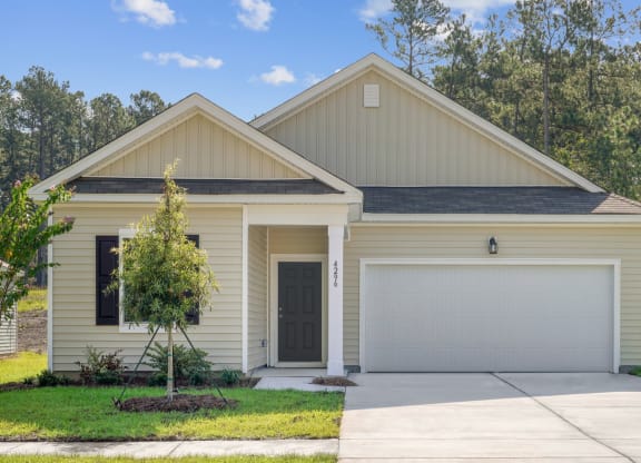 Front view of the Magnolia house painted in beige at Beacon at Ashley River Landing in Summerville, SC