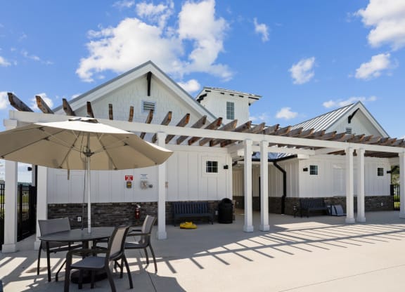 Poolside seating with umbrellas for shade at at Beacon at Ashley River Landing in Summerville, SC