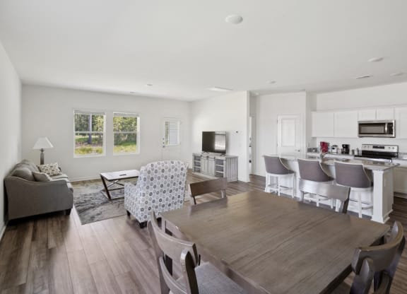 View of kitchen and living room from dining table in Poplar floor plan at Beacon at Ashley River Landing in Summerville, SC