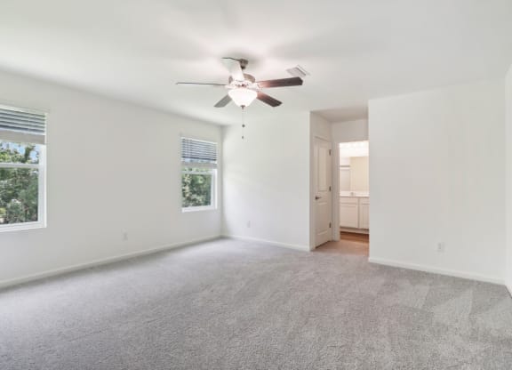 Sycamore master bedroom with ceiling fan and carpet flooring at Beacon at Ashley River Landing in Summerville, SC