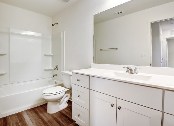 a bathroom with a toilet sink and bathtub