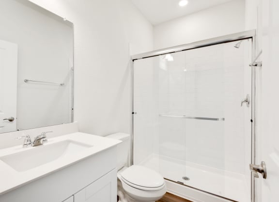 a bathroom with a toilet sink and shower