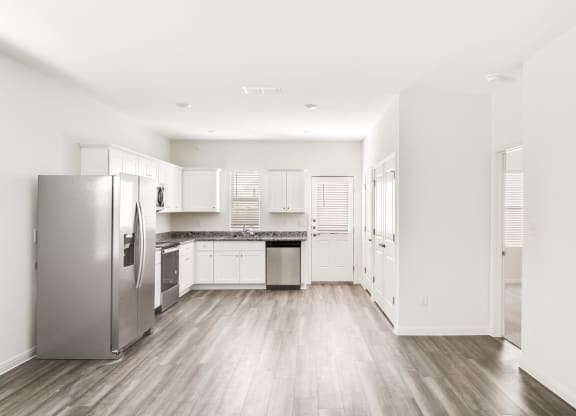 a kitchen with white cabinets and stainless steel appliances