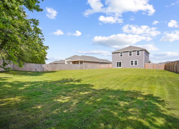 a yard with a house in the background at Beacon at Bunton Creek, Kyle, TX 78640
