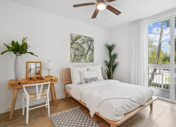 a bedroom with a bed and a desk with a chair