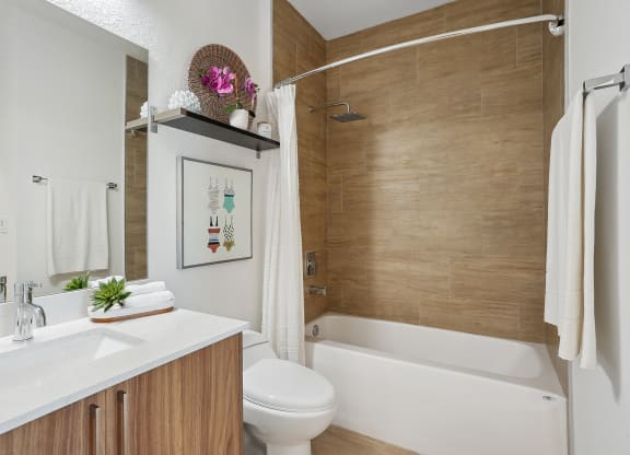 a bathroom with a white toilet next to a bathtub