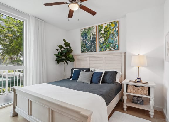 a bedroom with a bed and a ceiling fan