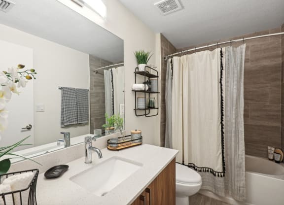 a bathroom with a sink and a toilet and a shower