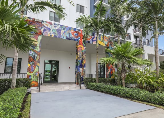 One of the entrances to our community with mural designs and palm trees at Bay Village 1 in Palmetto Bay, FL
