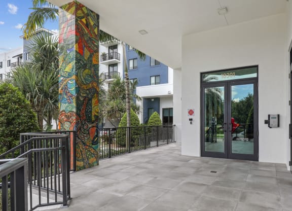 Entrance to our community lobby with pillars with artistic murals at Bay Village 1 in Palmetto Bay, FL