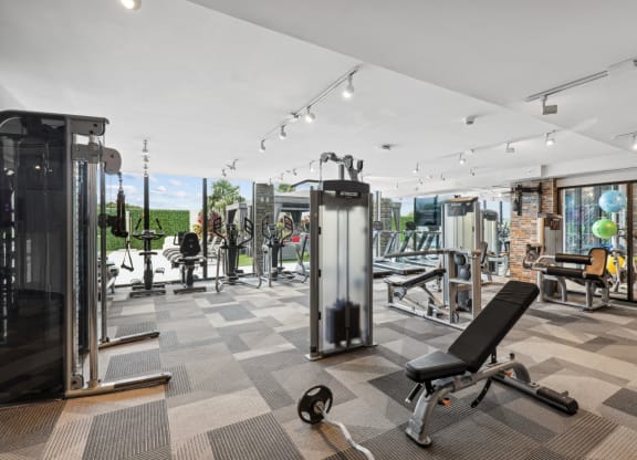 Fitness center with weights, cardio machines and cable weight machines at Bay Village 1 in Palmetto Bay, FL
