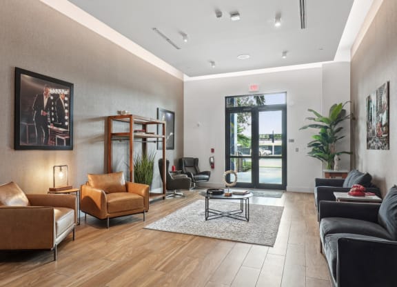 a living room with leather furniture and a door to a patio