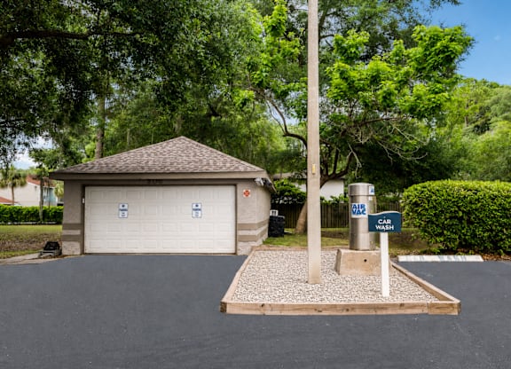 A car wash station is located in front of a garage.
