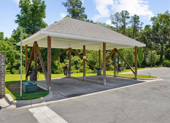 Covered car washing station with water hose and vacuum cleaners at Capital Grand Apartments in Tallahassee, FL
