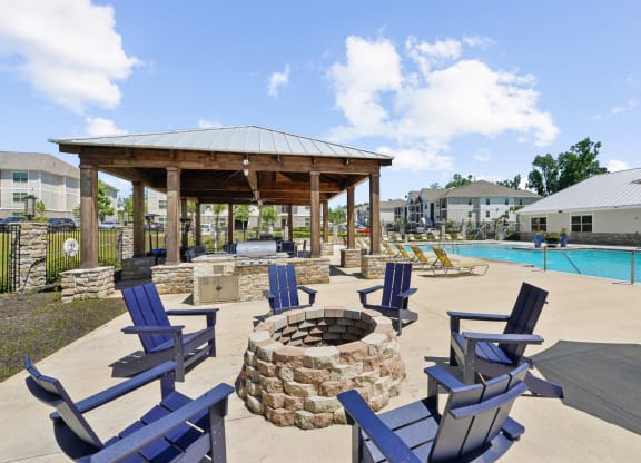 Firepit with blue chairs at Capital Grand Apartments in Tallahassee, FL