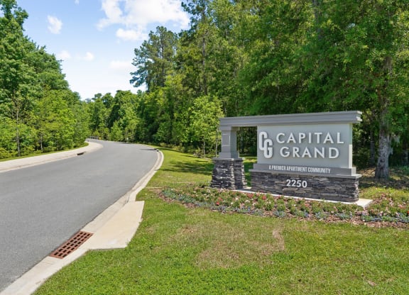 Capital Grand sign on the side of a road at Capital Grand Apartments in Tallahassee, FL